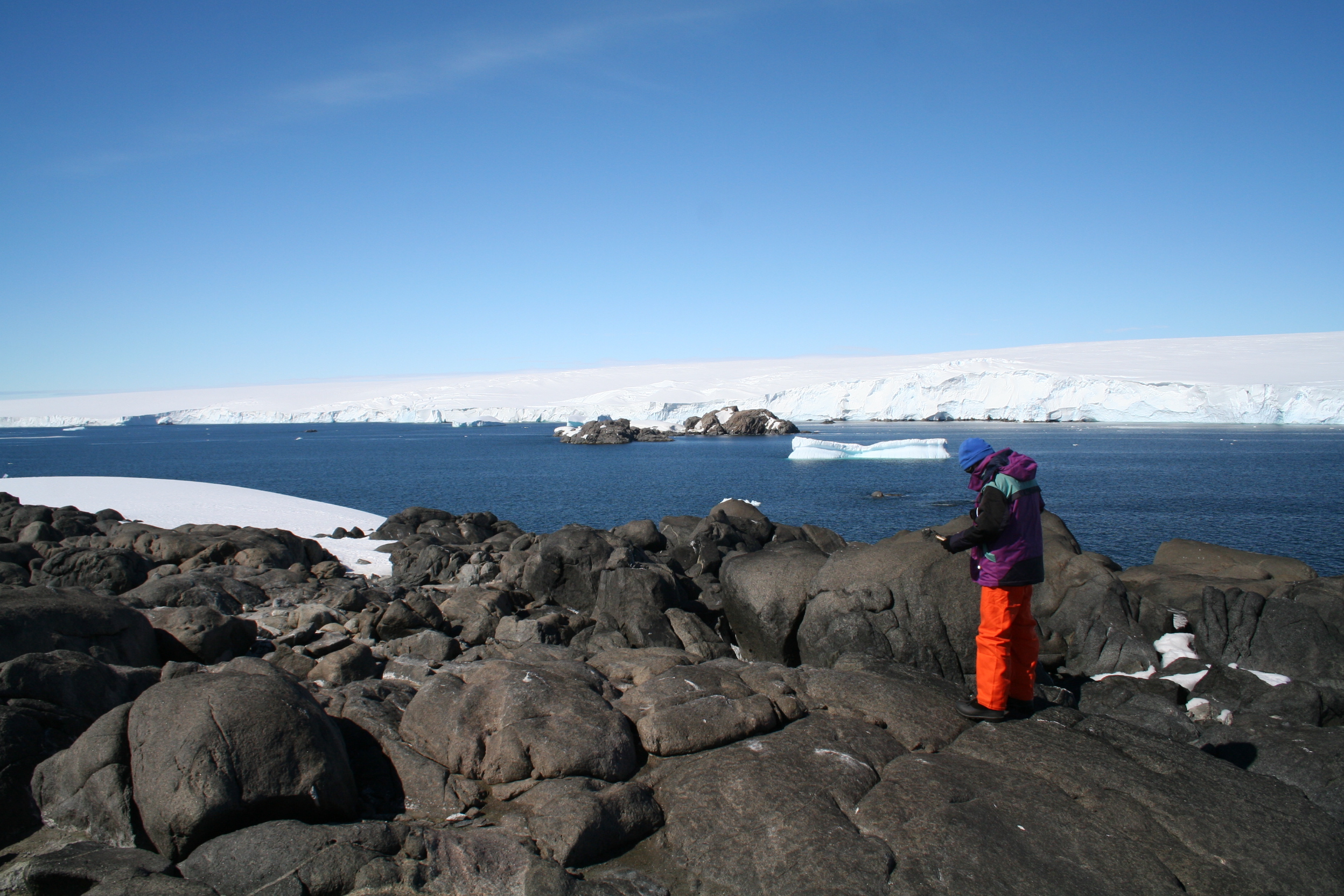 Image of geologist working on rocky island outcrops in Antarctica